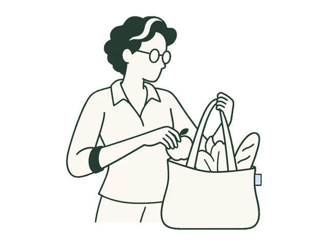 An older adult placing an apple in a grocery tote.
